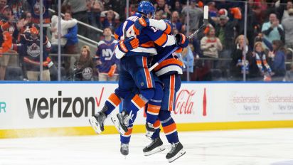 Getty Images - ELMONT, NEW YORK - APRIL 27: Robert Bortuzzo #41, Bo Horvat #14 and Alexander Romanov #28 of the New York Islanders celebrate Mathew Barzal #13 OT goal in the second OT against the Carolina Hurricanes in Game Four of the First Round of the 2024 Stanley Cup Playoffs at UBS Arena on April 27, 2024 in Elmont, New York. (Photo by Mike Stobe/NHLI via Getty Images)