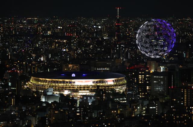 Tokyo 2020 Olympics - The Tokyo 2020 Olympics Opening Ceremony - Olympic Stadium, Tokyo, Japan - July 23, 2021. Drones form a shape of the world during the opening ceremony, seen above the Olympic Stadium REUTERS/Kim Kyung-Hoon