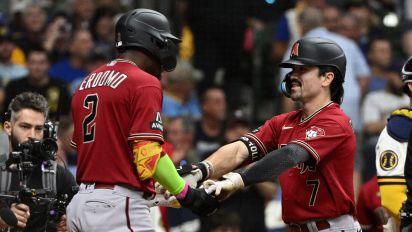 Reuters - Oct 3, 2023; Milwaukee, Wisconsin, USA; Arizona Diamondbacks shortstop Geraldo Perdomo (2) and left fielder Corbin Carroll (7) celebrate scoring in the third inning against the Milwaukee Brewers during game one of the Wildcard series for the 2023 MLB playoffs at American Family Field. Mandatory Credit: Michael McLoone-USA TODAY Sports