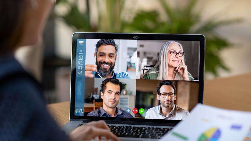 Back view of business woman talking to her colleagues about business plan in video conference. Multiethnic business team using laptop for a online meeting in video call. Group of businessmen and businesswomen smart working from home.