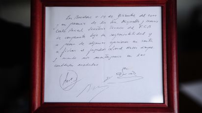 Associated Press - FILE - A framed copy of the napkin linking the 13-year-old Lionel Messi to FC Barcelona is seen in Barcelona, Spain on Jan. 5, 2012. British auction house Bonhams says the famous napkin that linked a young Lionel Messi to Barcelona has sold for $965,000. An agreement in principle to sign then 13-year-old Messi was written on the napkin almost 25 years ago at a Barcelona tennis club. (AP Photo/Manu Fernandez, File)