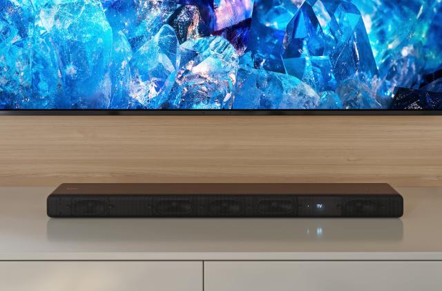 Sony's HT-A3000 soundbar, positioned on a white surface below a wall-hung TV.