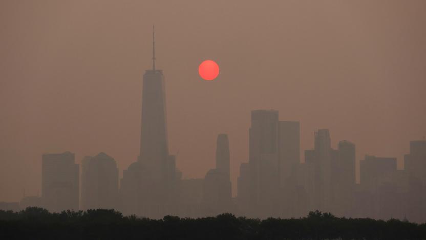 JERSEY CITY, NJ - JUNE 7: Smoke continues to shroud the sun as it rises behind the skyline of lower Manhattan and One World Trade Center in New York City on June 7, 2023, as seen from Jersey City, New Jersey.  (Photo by Gary Hershorn/Getty Images)