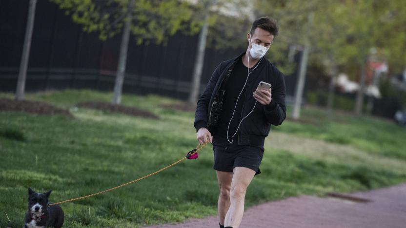 UNITED STATES - APRIL 2: A man walks a dog along New Jersey Avenue, NW, during the coronavirus outbreak on Thursday, April 2, 2020. (Photo By Tom Williams/CQ-Roll Call, Inc via Getty Images)