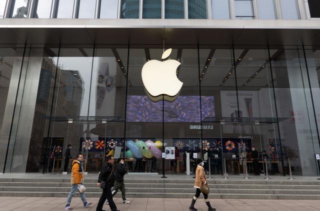 SHANGHAI, CHINA - DECEMBER 1, 2022 - Pedestrians walk past the Apple official retail store on Nanjing Road Pedestrian street in Shanghai, China, December 1, 2022. Apple's monthly market share in China reached 25%, the highest in the company's history. (Photo credit should read CFOTO/Future Publishing via Getty Images)