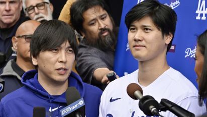 Getty Images - Los Angeles, CA - February 03:  Shohei Ohtani, right, of the Los Angeles Dodgers speaks to the media with the help of his interpreter Ippei Mizuhara during DodgerFest a celebration of the upcoming season with live entertainment, behind-the-scenes experiences, food, drinks and meeting the newest Dodgers at Dodger Stadium in Los Angeles on Saturday, February 3, 2024. (Photo by Keith Birmingham/MediaNews Group/Pasadena Star-News via Getty Images)