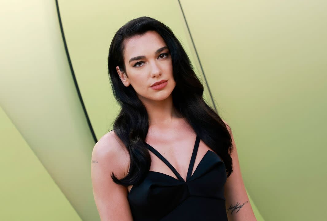 Dua Lipa Put a Sexy Twist on Business Casual With a Sheer Button Down and Black  Bra Top