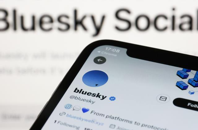 Bluesky Twitter account displayed on a phone screen and Bluesky Social website displayed on a screen in the background are seen in this illustration photo taken in Krakow, Poland on November 5, 2022. (Photo by Jakub Porzycki/NurPhoto via Getty Images)