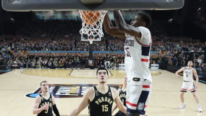 Getty Images - GLENDALE, ARIZONA - APRIL 08: (EDITORS NOTE: Image taken using a remote camera.) Samson Johnson #35 of the Connecticut Huskies dunks the ball with Zach Edey #15 of the Purdue Boilermakers defending during the second half in the NCAA Men's Basketball Tournament National Championship game at State Farm Stadium on April 08, 2024 in Glendale, Arizona. (Photo by Jamie Schwaberow/NCAA Photos via Getty Images)