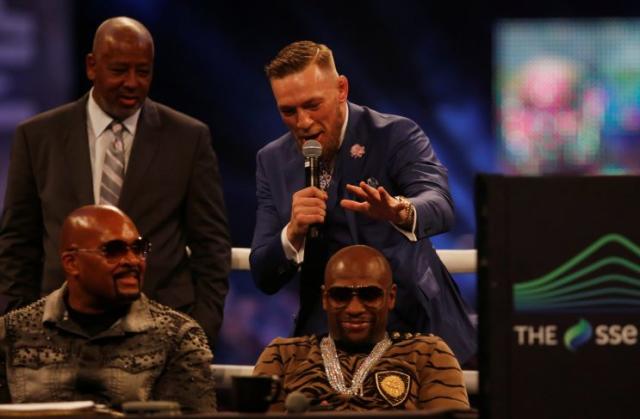 Conor McGregor goes to palm Floyd Mayweather's head in London against the advice of Dana White. (REUTERS)