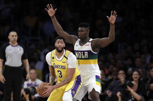 Los Angeles Lakers' Anthony Davis (3) is defended by New Orleans Pelicans' Zion Williamson (1) during the second half of an NBA basketball game Tuesday, Feb. 25, 2020, in Los Angeles. (AP Photo/Marcio Jose Sanchez)