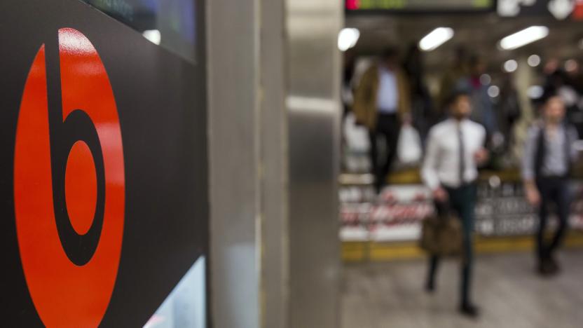 Commuters walk past a Beats brand display in the subway system of New York, May 29, 2014. Apple Inc will buy Beats for about $3 billion and bring recording mogul Jimmy Iovine into its ranks, hoping to win points with the music industry and help it catch up in fast-growing music streaming. As expected, Beats co-founders Iovine and rapper Dr. Dre will join Apple as part of the acquisition of the music streaming and audio equipment company.    REUTERS/Lucas Jackson (UNITED STATES - Tags: BUSINESS)