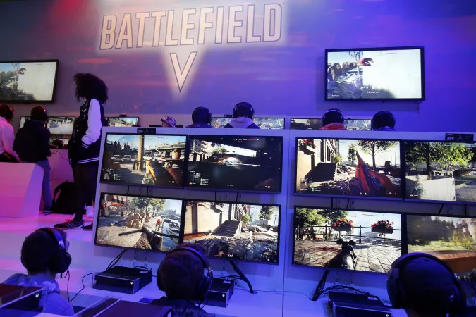 PARIS, FRANCE - OCTOBER 27:  Gamers play the video game "Battlefield V" developed by DICE and published by Electronic Arts (EA) during the 'Paris Games Week' on October 27, 2018 in Paris, France. 'Paris Games Week' is an international trade fair for video games and runs from October 26 to 31, 2018.  (Photo by Chesnot/Getty Images)