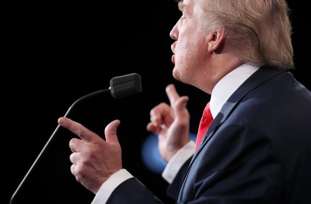 Donald Trump speaks as Hillary Clinton listens during their third and final 2016 presidential campaign debate at UNLV in Las Vegas, Nevada, U.S., October 19, 2016.  (Photo: Joe Raedle/Pool/Reuters) 