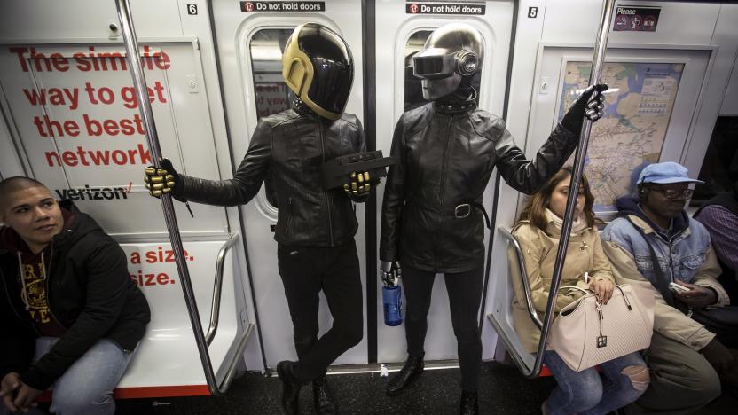 A couple dressed up as musical act Daft Punk ride the shuttle subway at Times Square station in the Manhattan borough of New York, October 31, 2015.   REUTERS/Carlo Allegri      TPX IMAGES OF THE DAY     