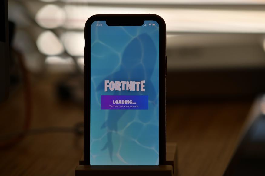 This illustration picture shows Epic Games' Fortnite loading on a smartphone in Los Angeles on August 14, 2020. - Apple and Google on August 13, 2020 pulled video game sensation Fortnite from their mobile app shops after its maker Epic Games released an update that dodges revenue sharing with the tech giants. (Photo by Chris DELMAS / AFP) (Photo by CHRIS DELMAS/AFP via Getty Images)