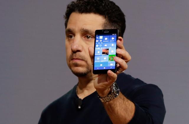 Microsoft vice president for Surface Computing Panos Panay shows a new Lumia 950 phone during a presentation, in New York, Tuesday, Oct. 6, 2015. The device will work with an optional dock. Users can attach a regular monitor, keyboard and mouse and work with apps on the phone just like you would on a Windows 10 desktop. (AP Photo/Richard Drew)