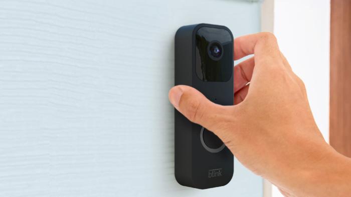 The Blink video doorbell is being installed wirelessly on a house to the side of the front door.  