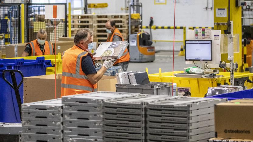 BRIESELANG, GERMANY - NOVEMBER 18: A worker packs items at an Amazon warehouse on November 18, 2021 in Brieselang, Germany. Many shoppers who fear gifts will be lacking due to the global supply chain disruption are buying their Christmas gifts early this year, both online and at brick and mortar retailers. (Photo by Maja Hitij/Getty Images)