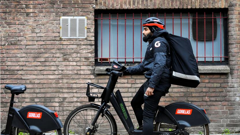 A courier of the fast grocery deliverer Gorillas sits on a bike as Amsterdam and Rotterdam have moved to ban new "dark store" delivery hubs in the city centres, in Rotterdam, Netherlands February 8, 2022. Picture taken February 8, 2022. REUTERS/Piroschka van de Wouw