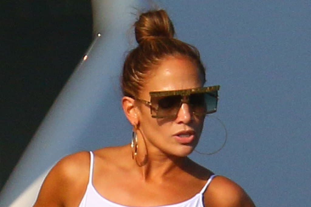 Jennifer Lopez’s cherry red bikini and brocade robe are the peak of holiday style