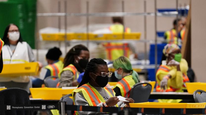 A Philadelphia election workers processes mail-in and absentee ballots for the general election at the Pennsylvania Convention Center, Tuesday, Nov. 3, 2020, in Philadelphia. (AP Photo/Matt Slocum)