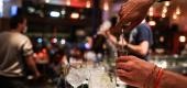 A waiter serves a cocktail at a bar. (Getty Images)