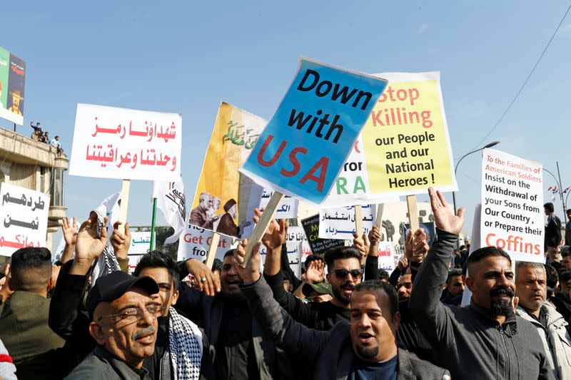 Singing anti-US slogans, Iraqi militia supporters celebrate the year since Soleimani’s death