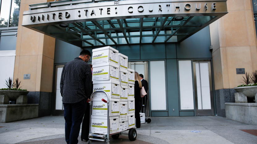 Court documents provided by Gibson, Dunn and Crutcher, LLP, the law firm representing Apple, are brought to the Oakland Federal courthouse for a weeks-long antitrust trial at federal court in Oakland, California, U.S., May 3, 2021.  REUTERS/Brittany Hosea-Small