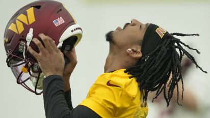 Associated Press - Washington Commanders first round draft pick quarterback Jayden Daniels puts on his helmet during an NFL rookie minicamp football practice in Ashburn, Va., Friday, May 10, 2024. (AP Photo/Susan Walsh)