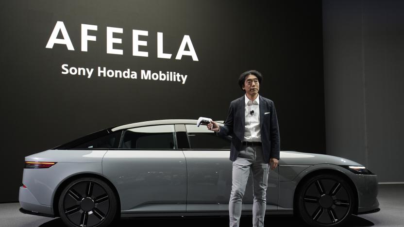 Izumi Kawanishi, president and COO of Sony Honda Mobility Inc., holds up a PlayStation controller after using it to drive an Afeela EV onto the stage during a Sony press conference ahead of the CES tech show Monday, Jan. 8, 2024, in Las Vegas. (AP Photo/John Locher)