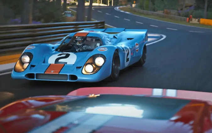 The Porsche 917 in Gulf livery seen racing in the video game 'Gran Turismo 7'.