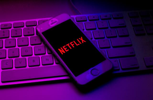 SPAIN - 2021/10/13: In this photo illustration a Netflix logo seen displayed on a smartphone on top of a computer keyboard. (Photo Illustration by Thiago Prudencio/SOPA Images/LightRocket via Getty Images)