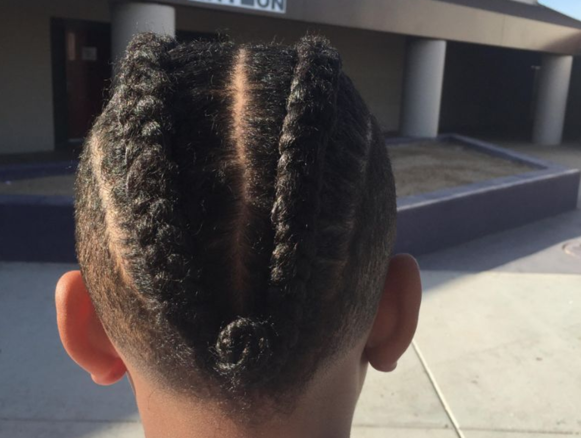 After a boy with braided hair violated his dress code, his mom switched  schools