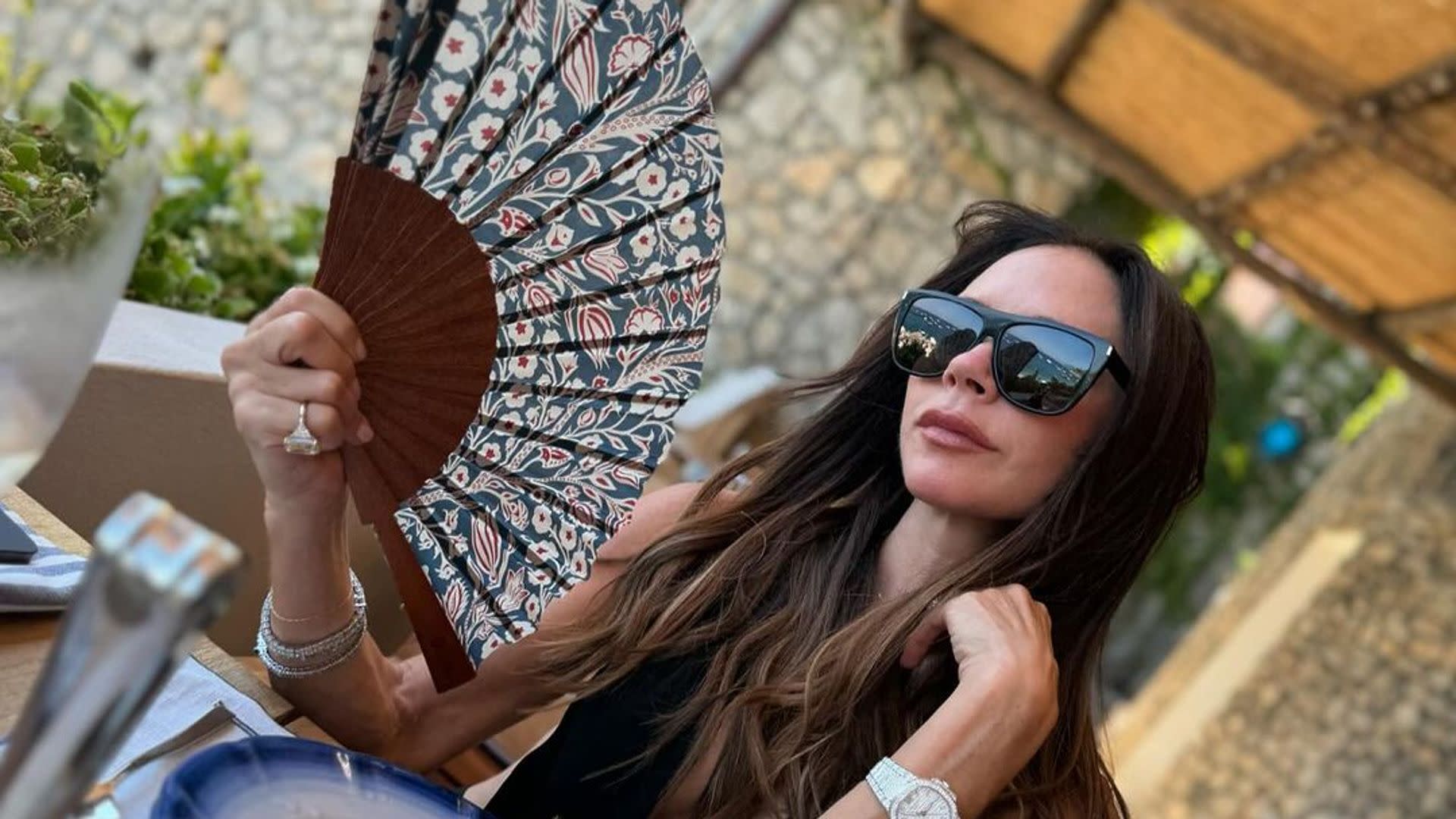 Victoria Beckham's muscles are next level in plunging beach dress as husband David reacts