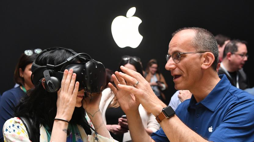 An Apple employee helps a member of the media try on an HTC Vive while testing the virtual reality capabilities of the new iMac during Apple's Worldwide Developers Conference in San Jose, California on June 5, 2017. / AFP PHOTO / Josh Edelson        (Photo credit should read JOSH EDELSON/AFP via Getty Images)