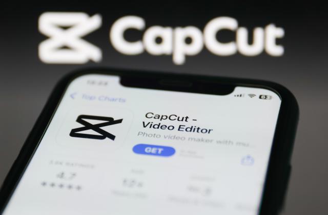 CapCut on App Store displayed on a phone screen and CapCut website displayed on a screen in the background are seen in this illustration photo taken in Krakow, Poland on January 19, 2023. (Photo by Jakub Porzycki/NurPhoto via Getty Images)