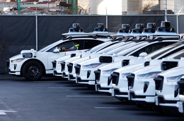 A worker parks a Jaguar I-Pace electric vehicle at Waymo's operations center in the Bayview district of San Francisco, California, U.S. October 19, 2021. Picture taken October 19, 2021.  REUTERS/Peter DaSilva