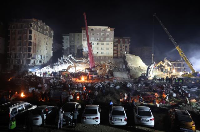 Relatives wait as the rescue operations continue near the site of a collapsed building in the aftermath of an earthquake in Hatay Province, Turkey, February 8, 2023. REUTERS/Umit Bektas