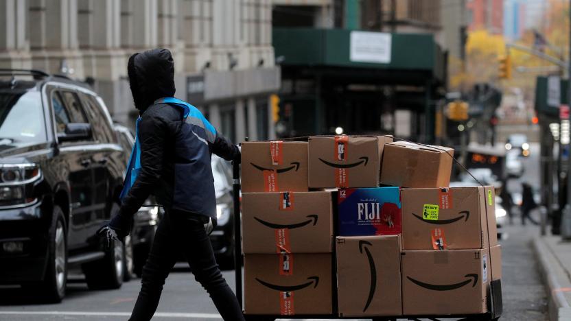 An Amazon delivery worker pulls a cart full of boxes for delivery on Cyber-Monday in New York City, U.S., November 29, 2021.  REUTERS/Brendan McDermid  REFILE - CORRECTING DATE