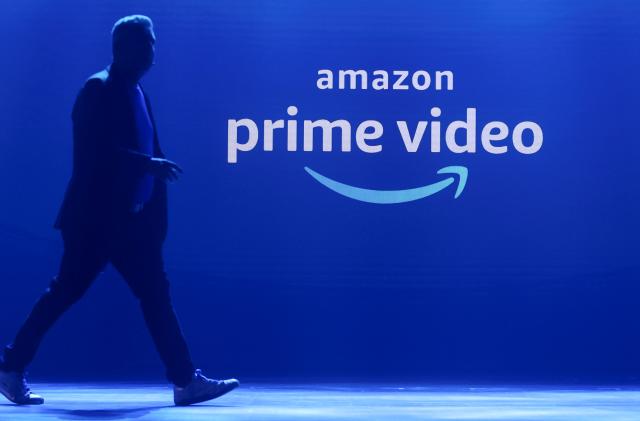 A man walks past a logo of Amazon Prime Video during a launch event in Mumbai, India, April 28, 2022. REUTERS/Francis Mascarenhas