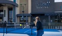 A person on a court holding a racket .