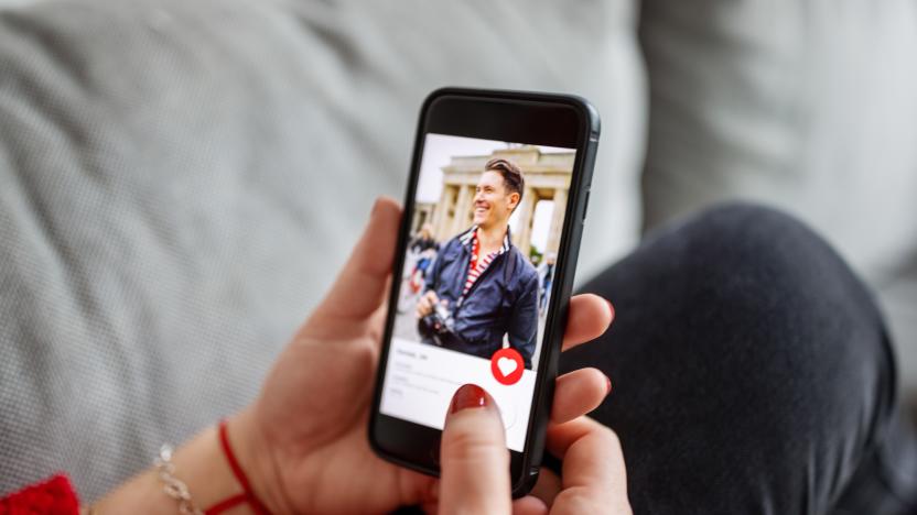 Close-up of a female using a dating app on smart phone. Woman looking at man on an online dating app on her mobile phone.