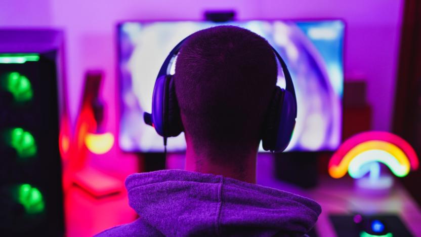 Young man wearing headset and play computer video games online - Home isolated for coronavirus outbreak