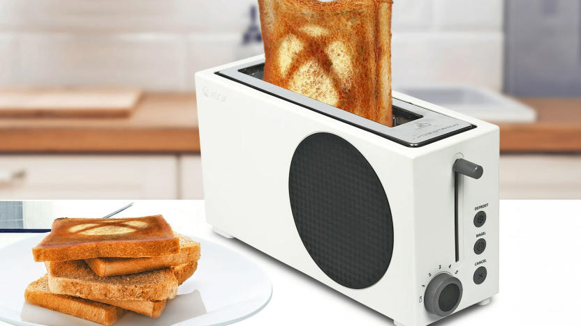 A white toaster styled to look like an Xbox Series S sits on a kitchen counter with the Xbox logo burned/toasted onto bread that's sticking out of the toaster slot.