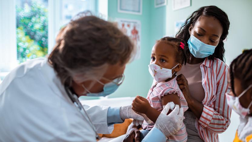 Close up of a mother taking her daughter to the pediatrician to get vaccinated