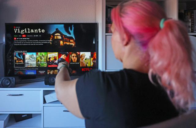 MADRID, SPAIN - OCTOBER 14: A user connects to the Netflix platform on October 14, 2022, in Madrid, Spain. The U.S. entertainment company and streaming platform has decided to activate its first plan with advertising in November, which will be available in 12 countries. Depending on the country, between 5% and 10% of the titles will not be available in the basic version. The new cheaper plan with ads will cost 5.49 euros per month, two and a half euros less than at present. 