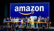 Amazon staffers joyfully cut a ribbon (with Virginia governor Glenn Youngkin) at a ceremony for its second headquarters.