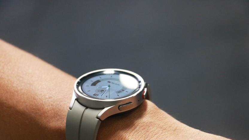 The Samsung Galaxy Watch 5 Pro on a wrist, with some lights reflecting off its screen.