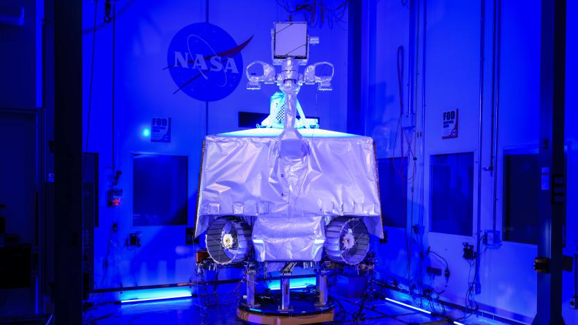 A contraption inside a room with the NASA logo in the background.
